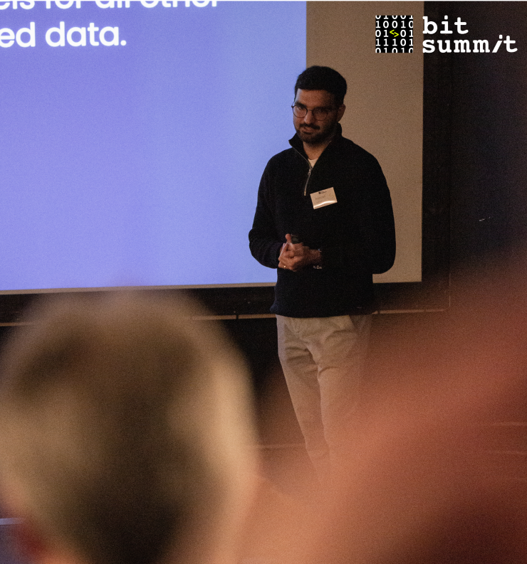 A man presenting on bit summit event