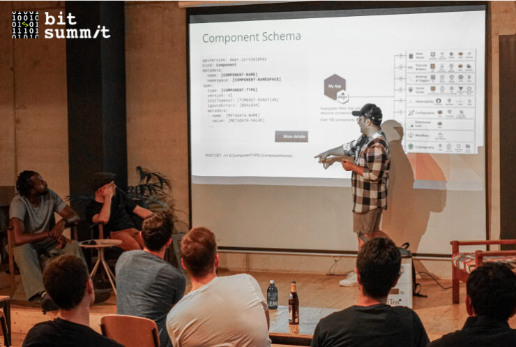 A man presenting about Golang to a group of people