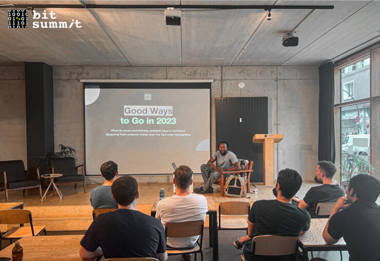A man presenting about Golang to a group of people